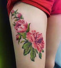 watercolor flower thigh tattoo