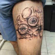 Nautical compass thigh tattoo