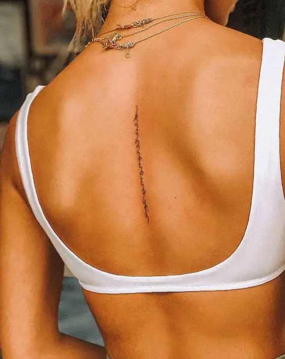 Vertical Word Tattoo On Back 