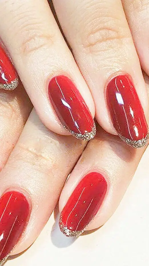 Red Nails With Gold Glitter French Tips 