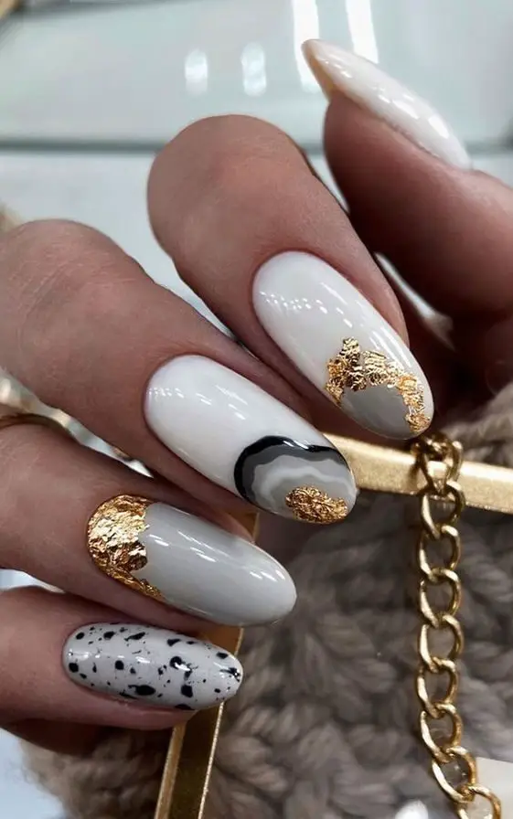 White Oval Nails With Gold And Black Abstract Patterns 